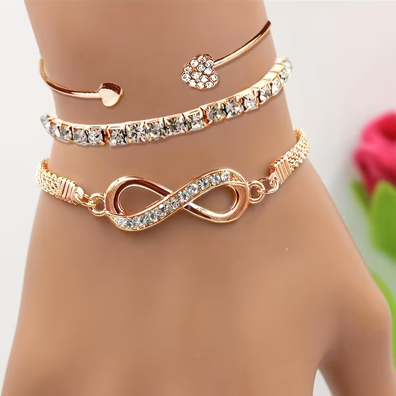 A Set of Three Women's Bracelets and Bangles with Rhinestone Heart Designs